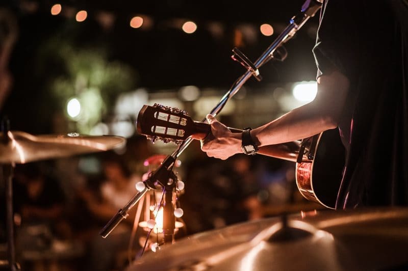 live musician singing with guitar